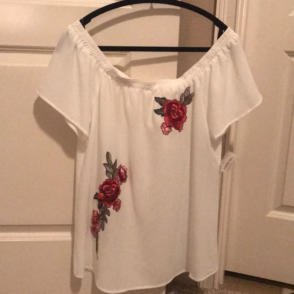 Off the shoulder white with flower appliqué.